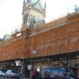 Orange debris netting installed on scaffold face of construction site maximum-visibility application | CMT Group UK