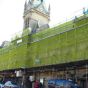 Yellow debris netting installed on scaffold face of construction site high-visibility application | CMT Group UK
