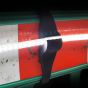 UtilityLite rubber barrier strap fitted to red and white construction barrier with LED strip illuminated | CMT Group UK