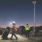 Construction operatives deploying CMT Power portable lighting tower on active site at dusk | CMT Group UK