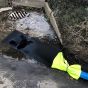 Economy Sediment Filter Bag 150x35cm deployed at roadside drain with pump discharge hose | CMT Group UK