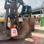 DripLock Hose Cap on excavator hydraulic hoses active construction site with hi-vis operatives in background | CMT Group UK