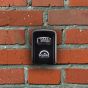 Squire wall mounted combination key safe 4-wheel die cast installed on exterior brick wall | CMT Group UK