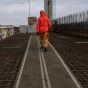 Mobi-Mat heavy duty walkway mat unrolled over rebar deck construction site operative walking on mat | CMT Group UK