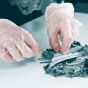 Clear vinyl disposable gloves worn on hands during food preparation showing clear finish and close fit | CMT Group UK