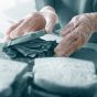 Clear vinyl powder-free disposable gloves worn on hands during food preparation showing clear finish | CMT Group UK