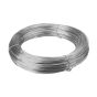 Stainless steel tying wire being twisted by hand around steel reinforcement bar on construction site | CMT Group UK