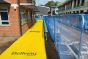 Yellow Anti-Slip Spaghetti Site Mat - 12mm x 1m x 10m Roll custom branded walkway mat installed outside a building | CMT Group