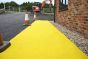 Yellow Anti-Slip Spaghetti Site Mat - 12mm x 1m x 10m Roll installed as a temporary walkway on a construction site | CMT Group