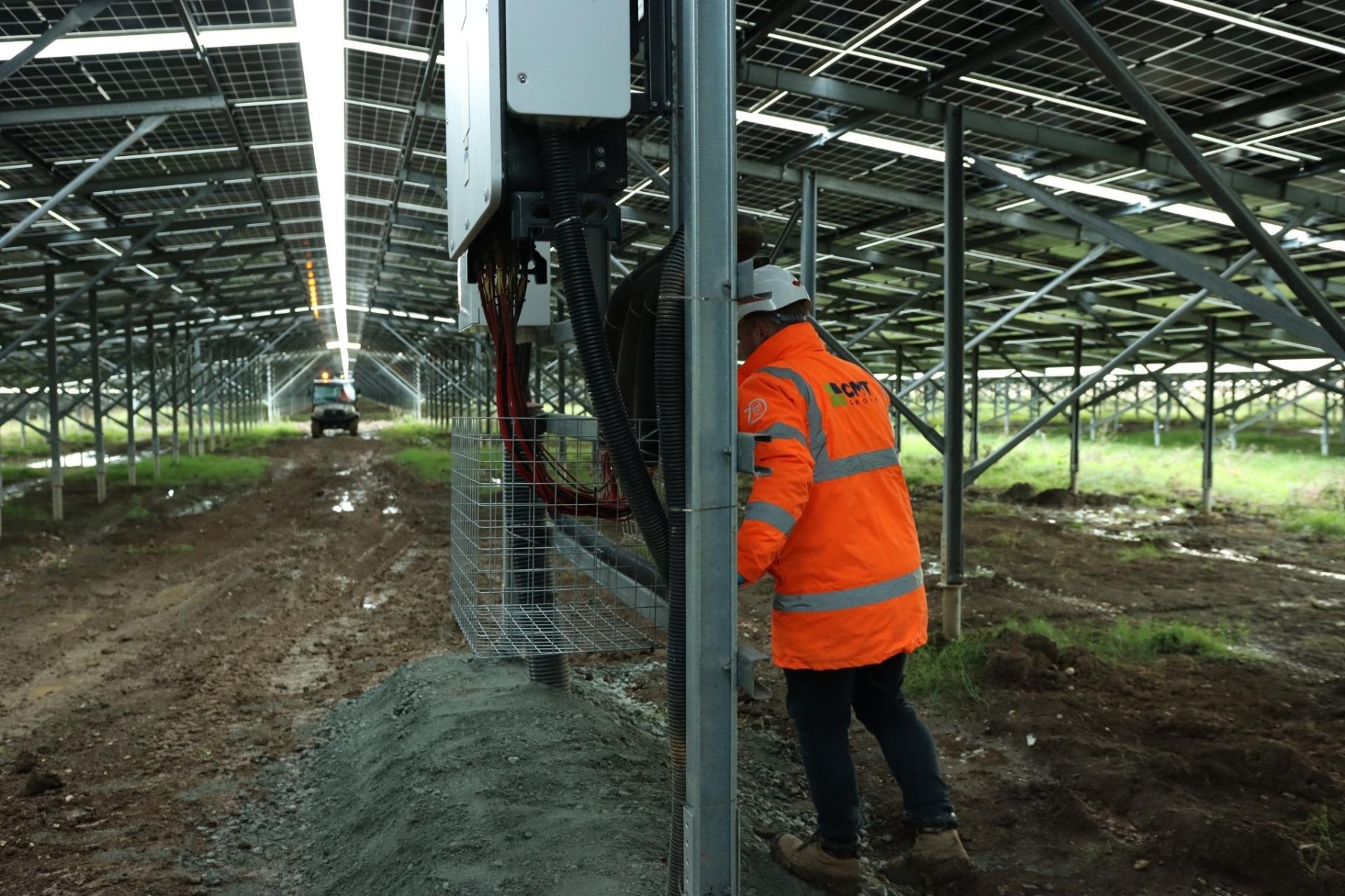 CMT Group engineer installing InverShield Mesh Box around solar inverter cable runs at UK agrivoltaic site